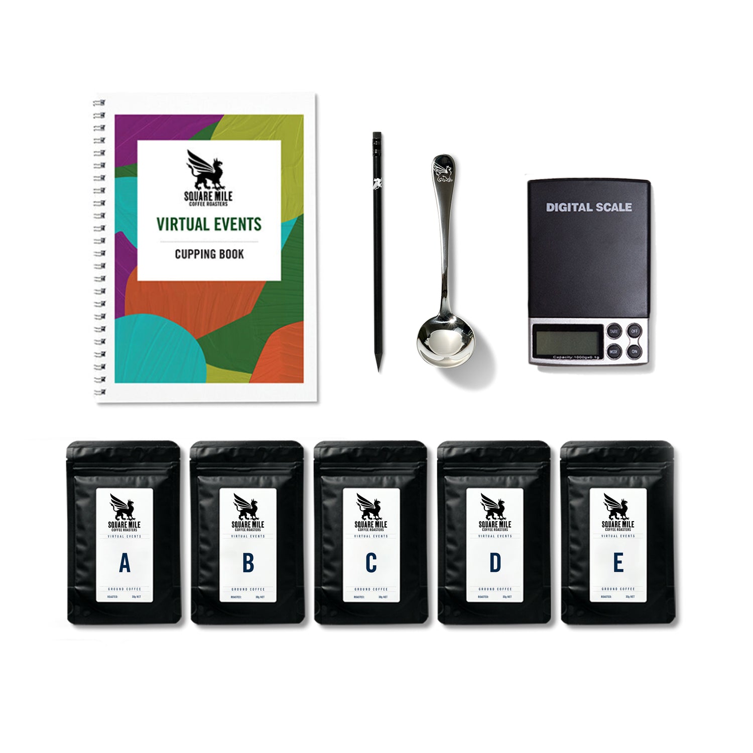 The contents of a Square Mile coffee tasting kit including a cupping book, coffee bags, cupping spoon, pencil and scale.
