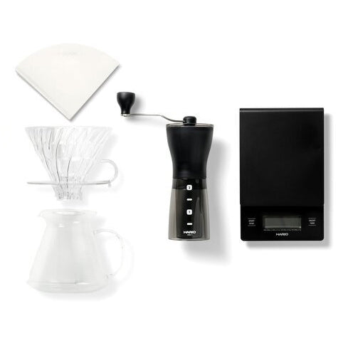 The contents of the Square Mile Virtual Tasting kit add ons including filter papers, plastic V60, coffee grinder and scale.